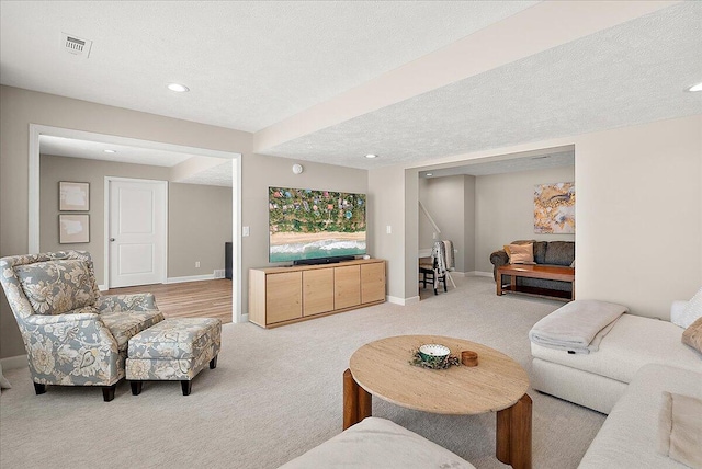 carpeted living room with a textured ceiling