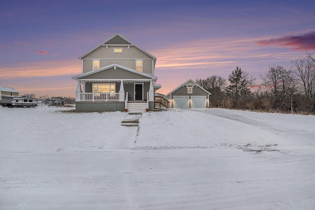 view of front facade with a garage, a porch, and an outdoor structure