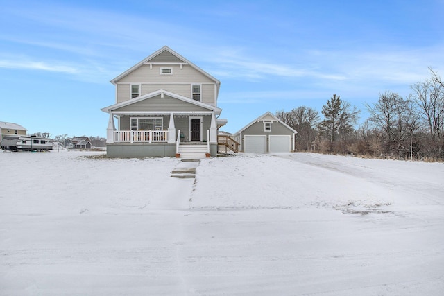 view of front facade with an outbuilding, covered porch, and a garage