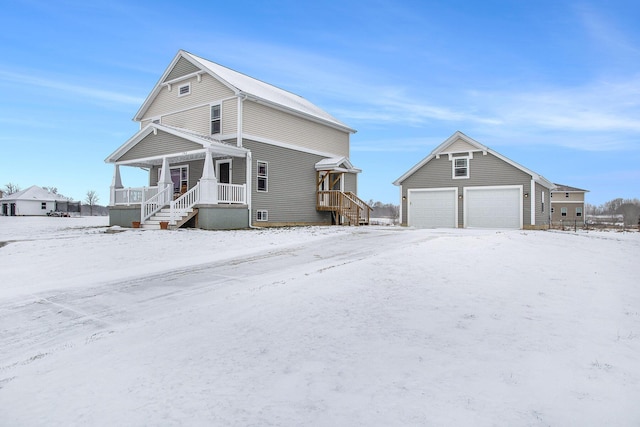 view of front of house with an outbuilding, a porch, and a garage