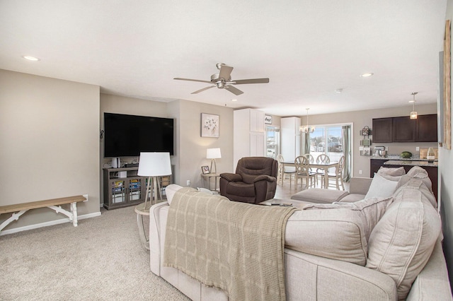 living room with ceiling fan and light colored carpet