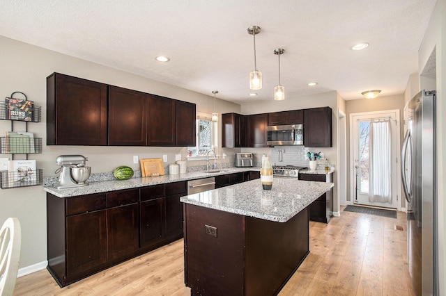 kitchen featuring dark brown cabinetry and stainless steel appliances