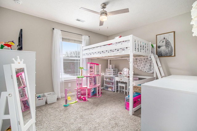 bedroom featuring ceiling fan, a textured ceiling, and carpet flooring