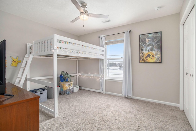 bedroom with ceiling fan, a closet, and light carpet