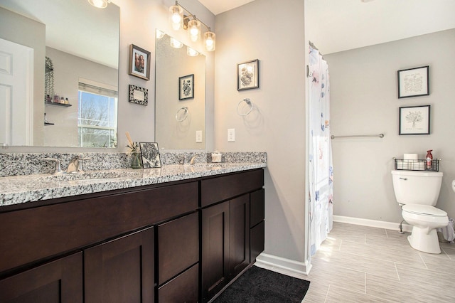 bathroom with toilet and vanity