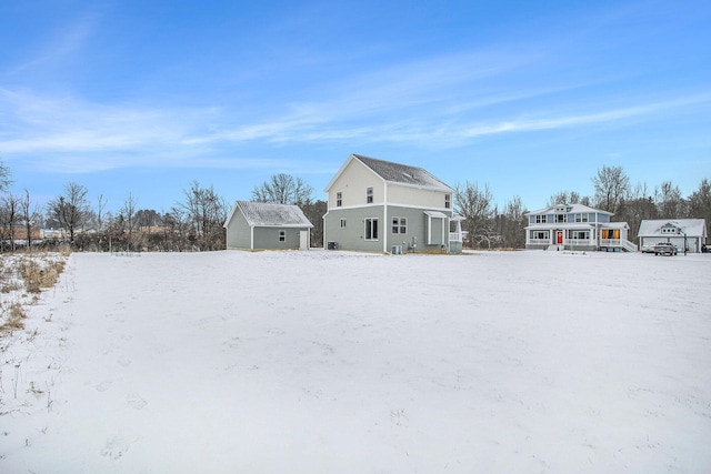 view of snow covered rear of property