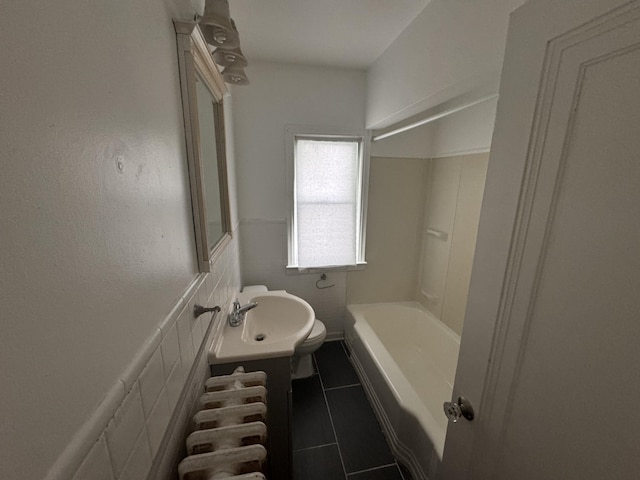 bathroom featuring sink, tile walls, and tile patterned flooring