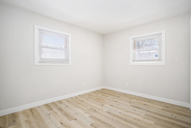 unfurnished room with light wood-type flooring