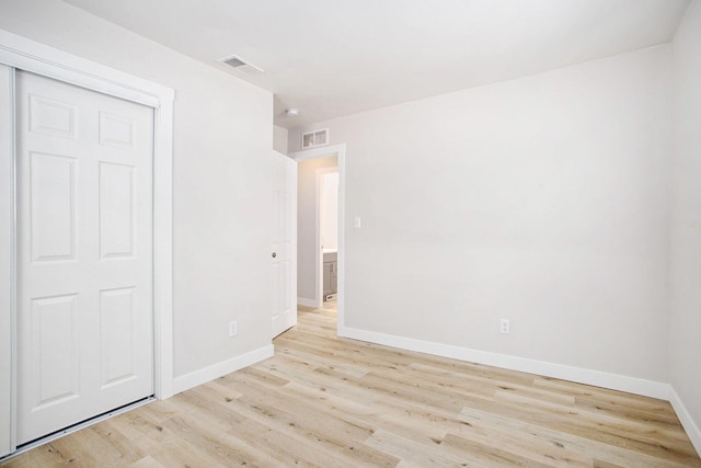 spare room featuring light hardwood / wood-style floors