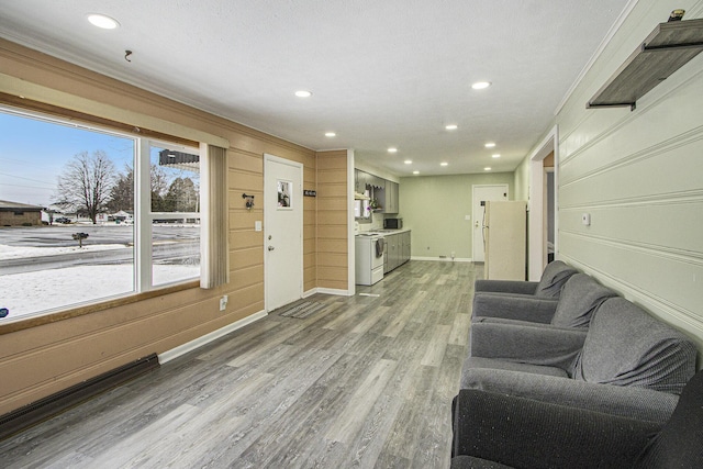 living room with ornamental molding and hardwood / wood-style flooring