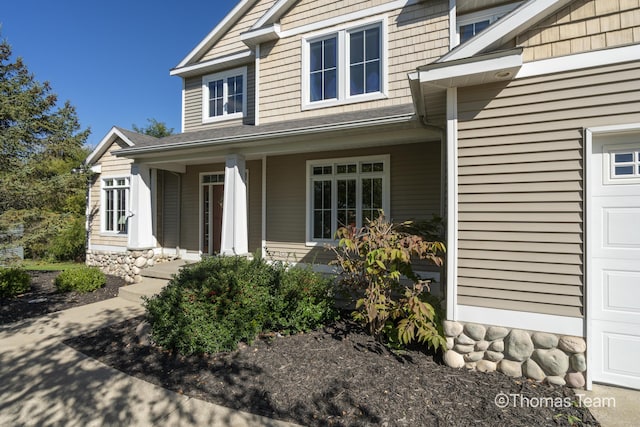 view of exterior entry with covered porch