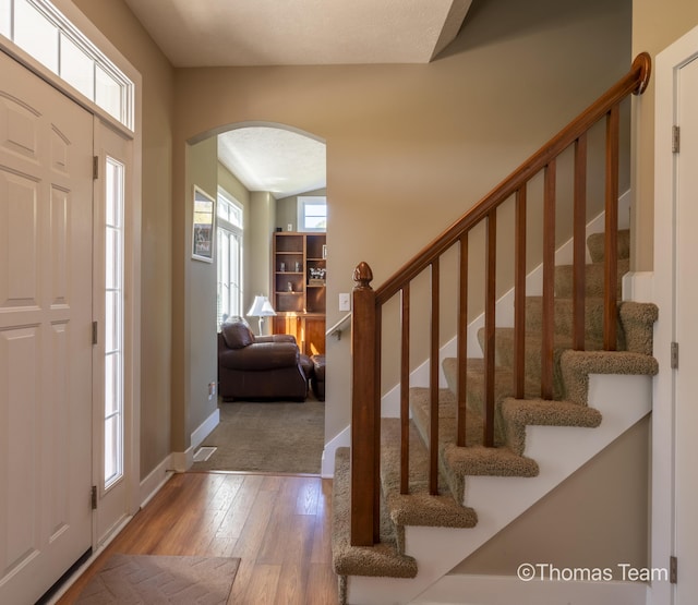 foyer entrance featuring a textured ceiling and hardwood / wood-style flooring