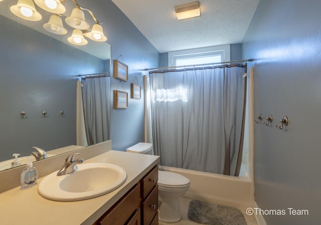 full bathroom with a textured ceiling, toilet, shower / bath combination with curtain, and vanity