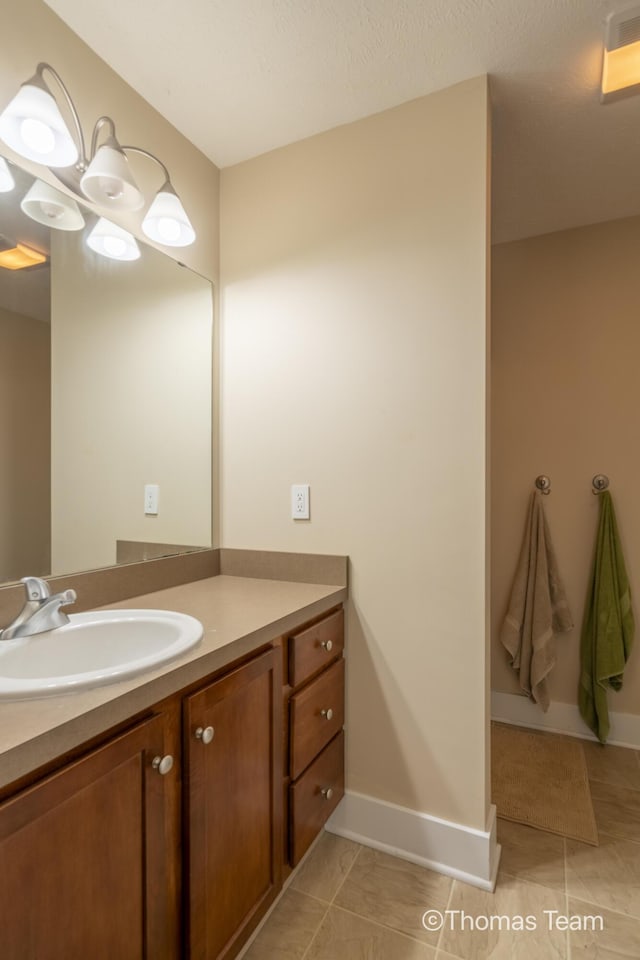 bathroom featuring tile patterned flooring and vanity