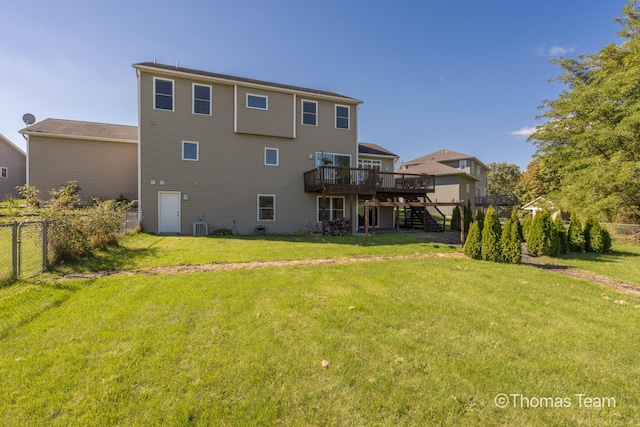 back of house with a deck, central AC unit, and a lawn