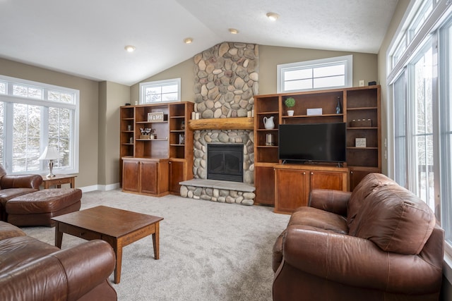 living room featuring a textured ceiling, lofted ceiling, light colored carpet, and a stone fireplace