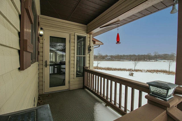 view of snow covered back of property