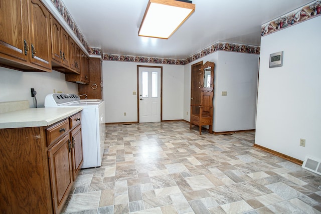 laundry room featuring cabinets and washer and clothes dryer