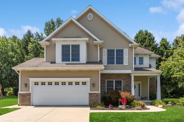 craftsman-style home featuring driveway, stone siding, and a garage