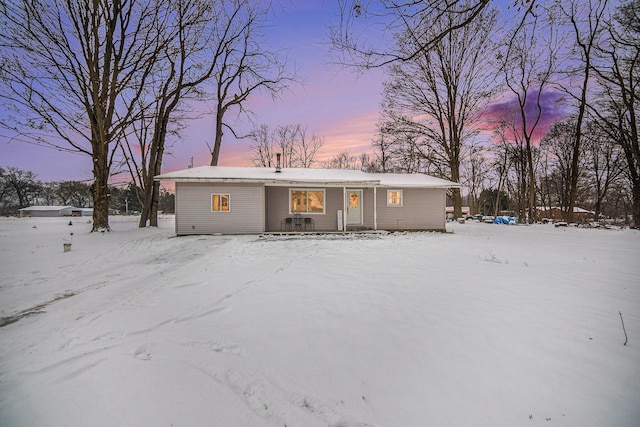 view of snow covered rear of property