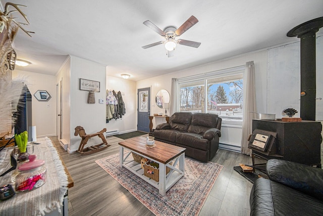 living room featuring ceiling fan, a baseboard heating unit, and dark hardwood / wood-style floors