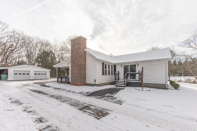 view of front of property with a garage and an outbuilding