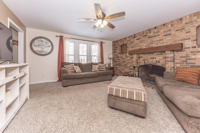 living room with a brick fireplace, carpet flooring, brick wall, and ceiling fan