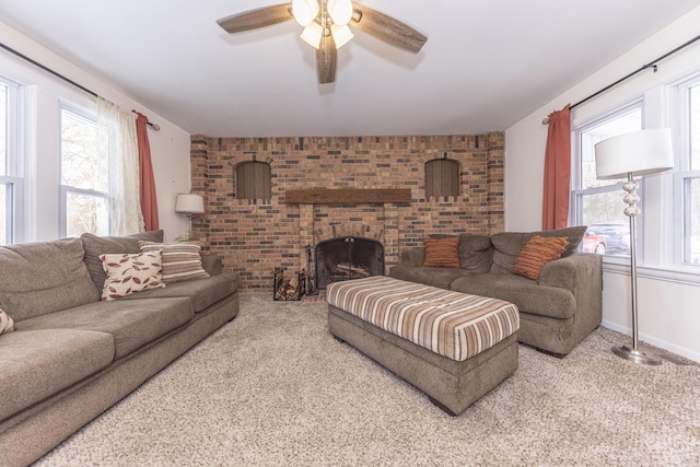 carpeted living room featuring ceiling fan, brick wall, and a fireplace