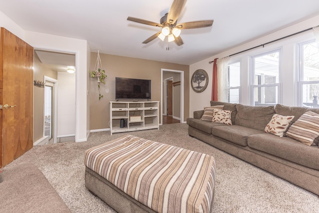 carpeted living room with ceiling fan