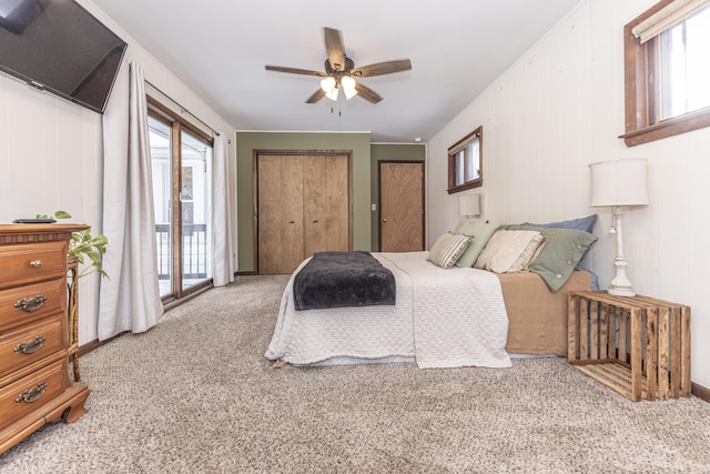 bedroom featuring light carpet, ceiling fan, and multiple windows