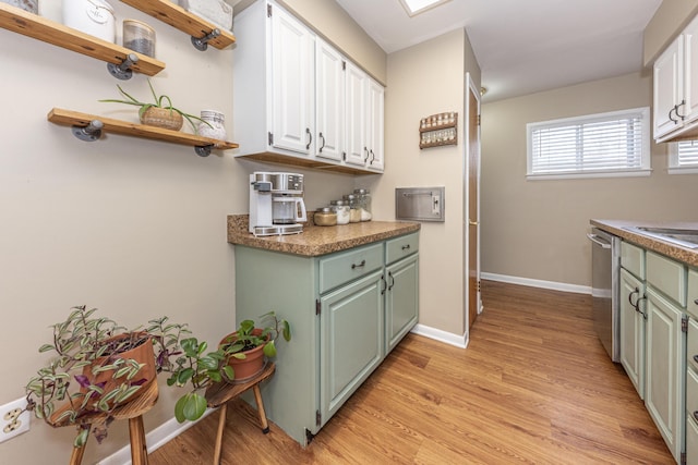 kitchen with light hardwood / wood-style floors, white cabinetry, and stainless steel dishwasher