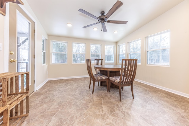 dining space with ceiling fan and vaulted ceiling