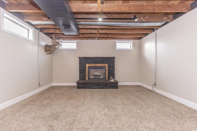 basement with carpet and a fireplace