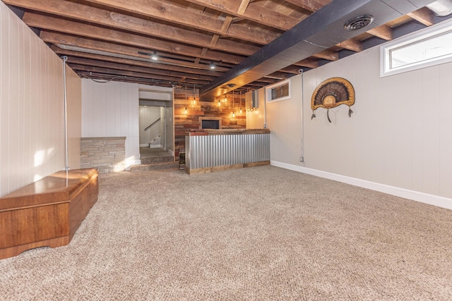 basement with bar area and carpet flooring