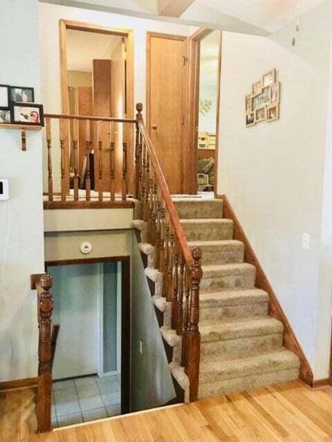 stairway featuring hardwood / wood-style flooring and a towering ceiling