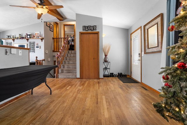 foyer with lofted ceiling with beams, hardwood / wood-style flooring, and ceiling fan