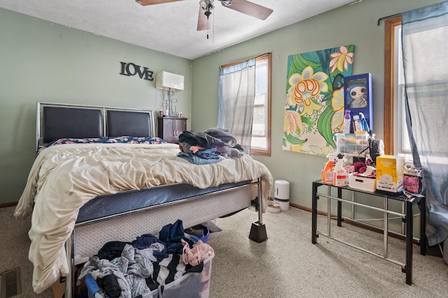 bedroom with a textured ceiling and ceiling fan