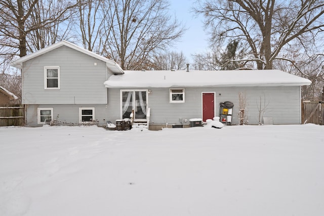 view of snow covered back of property