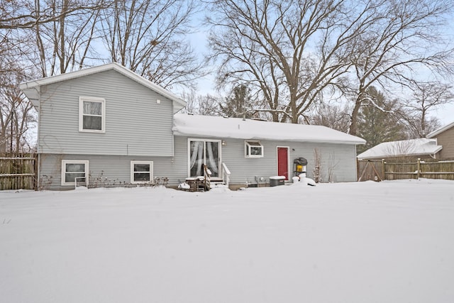 view of snow covered back of property