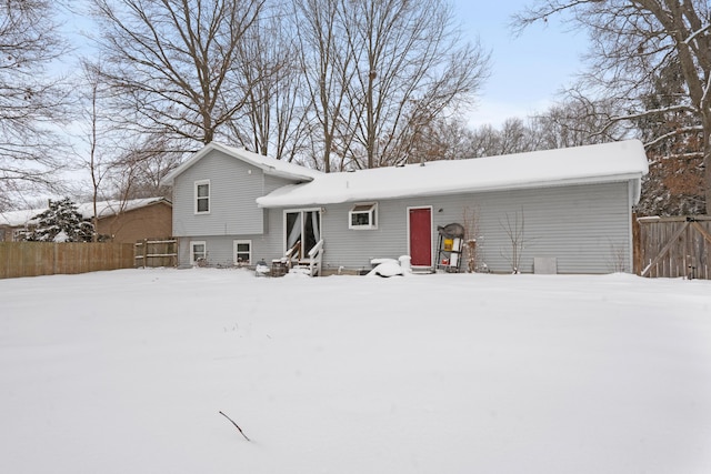 view of snow covered back of property