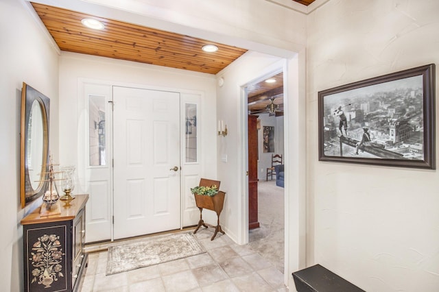 carpeted foyer with wooden ceiling