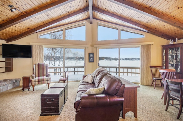 living room with light carpet, a water view, high vaulted ceiling, and beamed ceiling