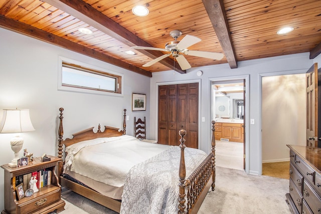 bedroom with ceiling fan, light colored carpet, ensuite bathroom, a closet, and wooden ceiling