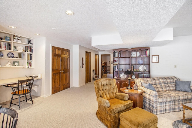 carpeted living room with built in features and a textured ceiling