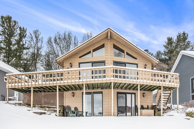 snow covered property with a deck