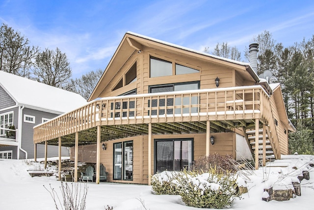 snow covered property featuring a deck