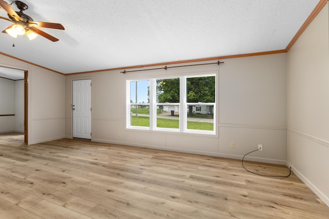 empty room with ceiling fan, light wood-type flooring, crown molding, and a textured ceiling