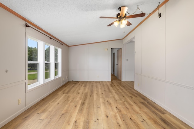 unfurnished room featuring ceiling fan, a textured ceiling, light hardwood / wood-style flooring, and crown molding