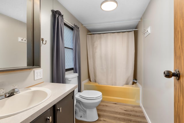 full bathroom with toilet, vanity, wood-type flooring, shower / bath combination with curtain, and a textured ceiling