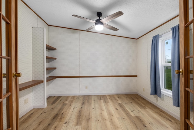 spare room featuring ceiling fan, crown molding, a textured ceiling, and light hardwood / wood-style floors